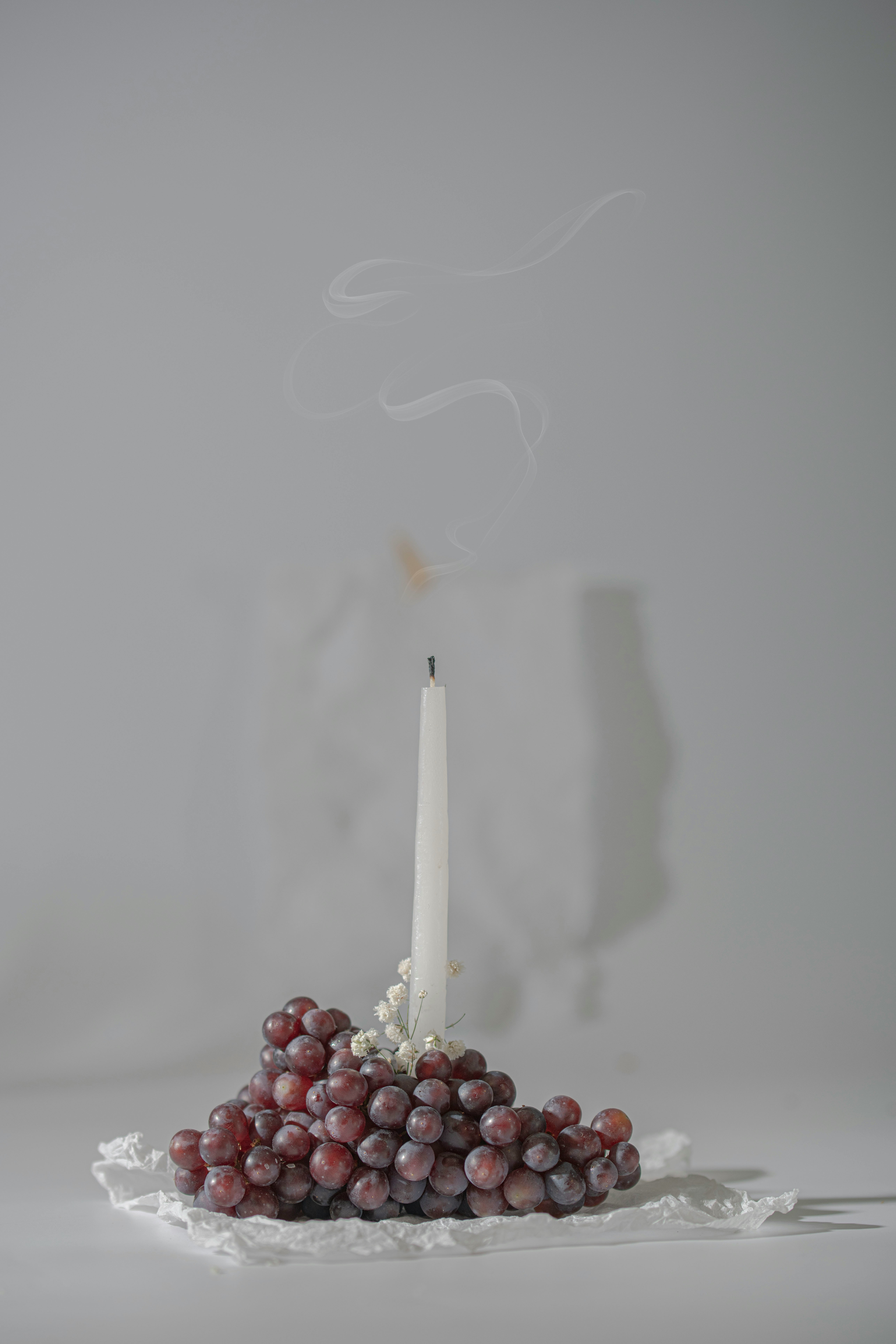 white and red candles on white surface